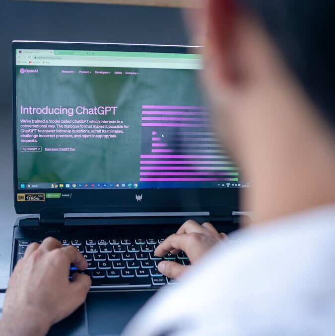 a man sitting in front of a laptop computer