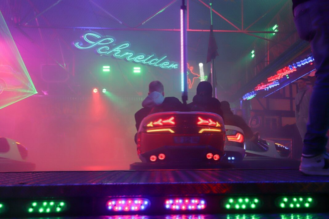 A car driving down a street at night