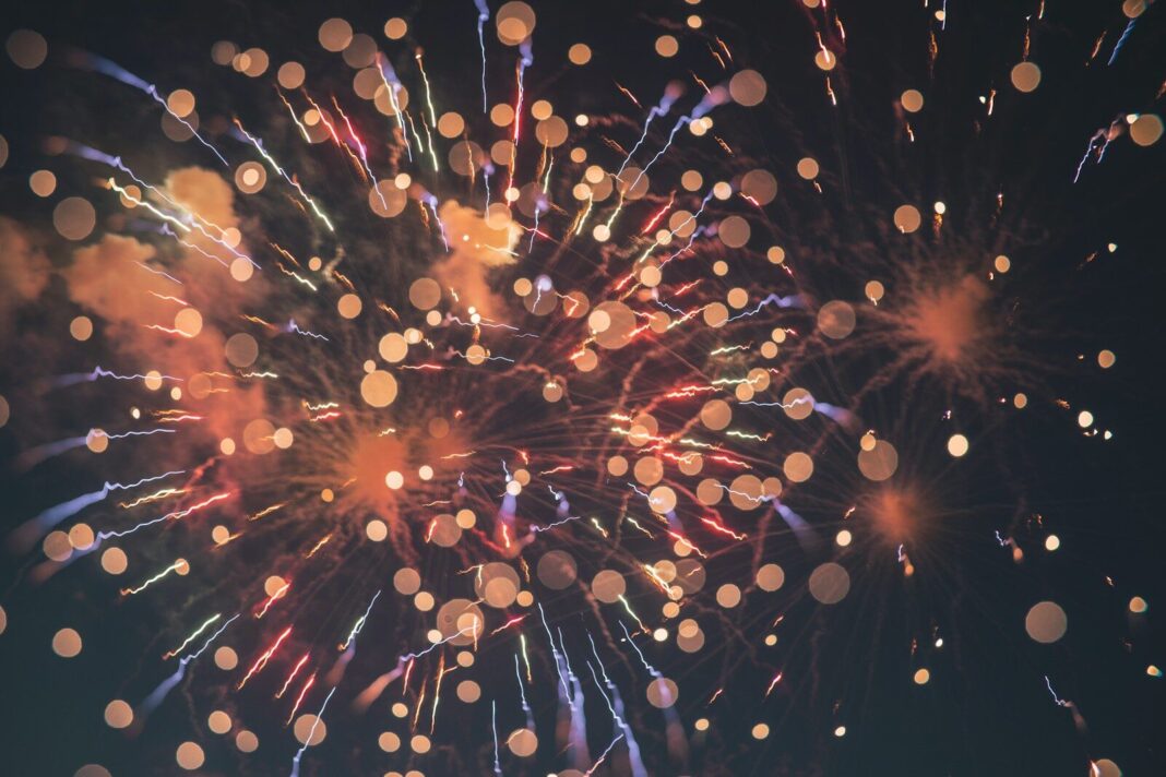Bright colorful fireworks exploding in the night sky with a soft bokeh effect